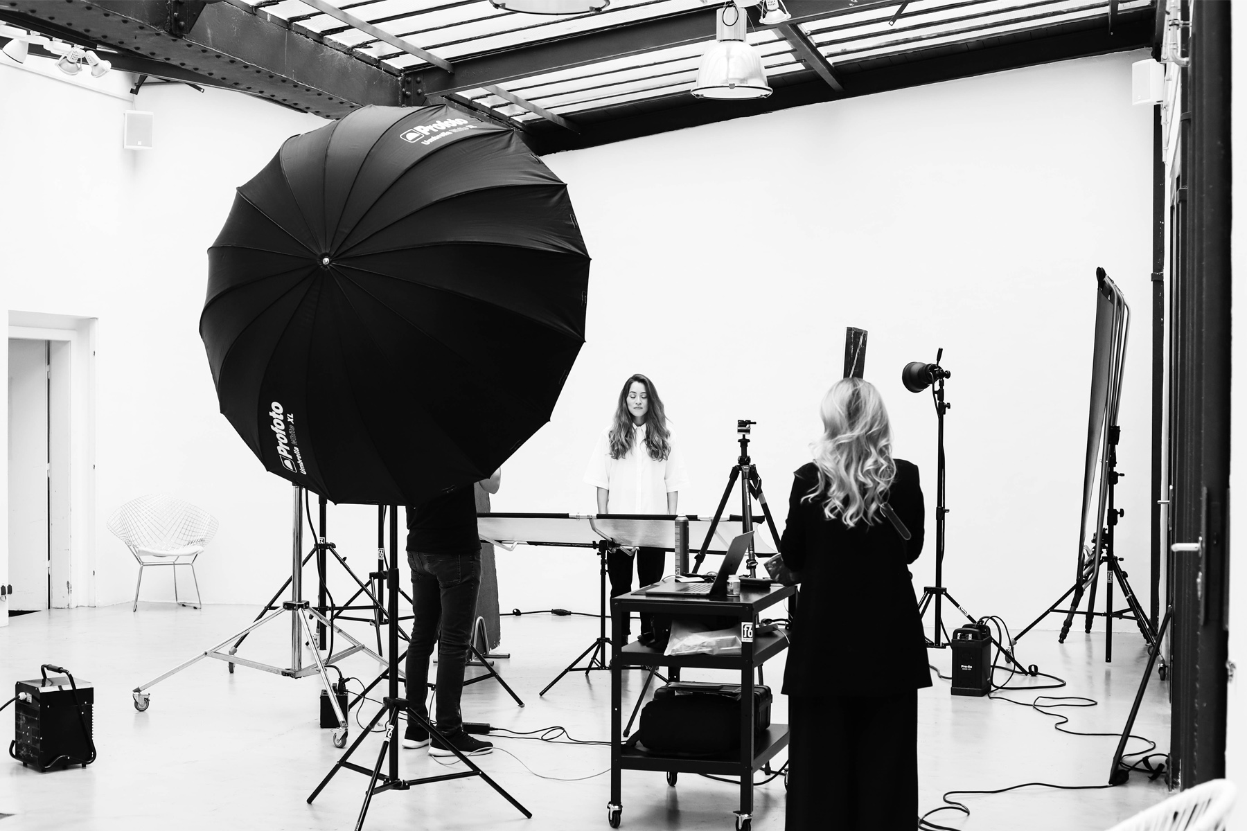 Frau mit langen dunklen Haaren und in weißer Bluse vor weißer Leinwand beim Coopers AG Fotoshooting mit Werner Streitfelder
